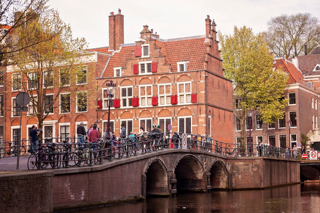 People on a canal bridge in central Amsterdam near the Nine Streets cafes, close to Ruma